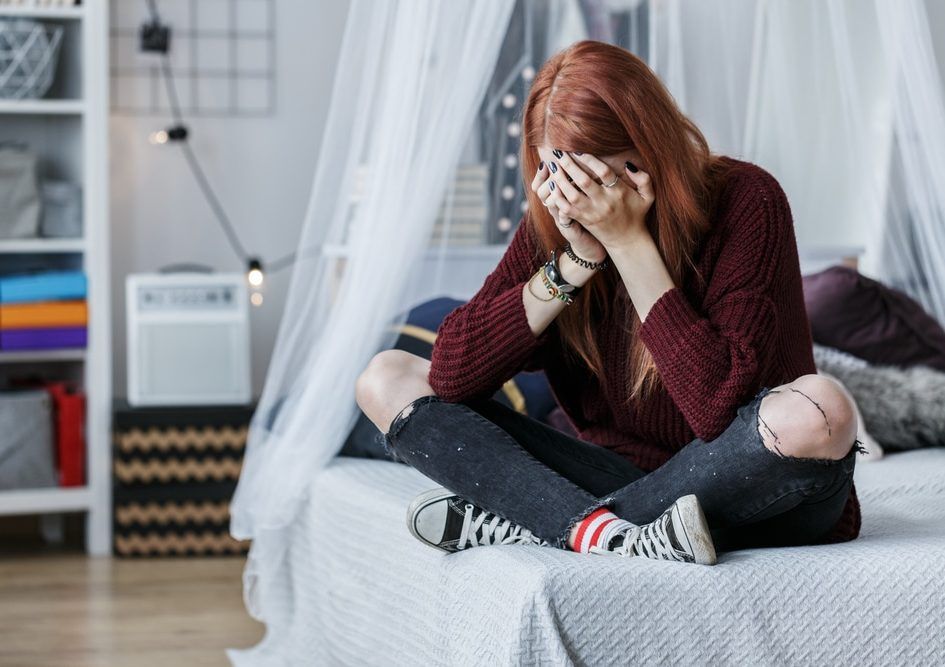 Rebellious woman crying on bed